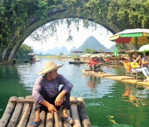 Our guide steering the bamboo raft along the Yulong River in Yangshuo China