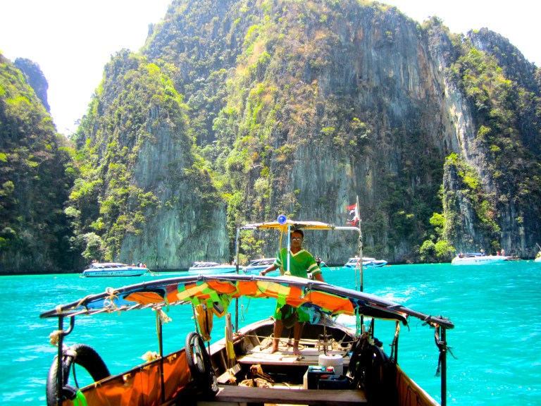 Our long-tail boat driver taking us to see the limestone cliffs in Ko Phi Phi, Krabi