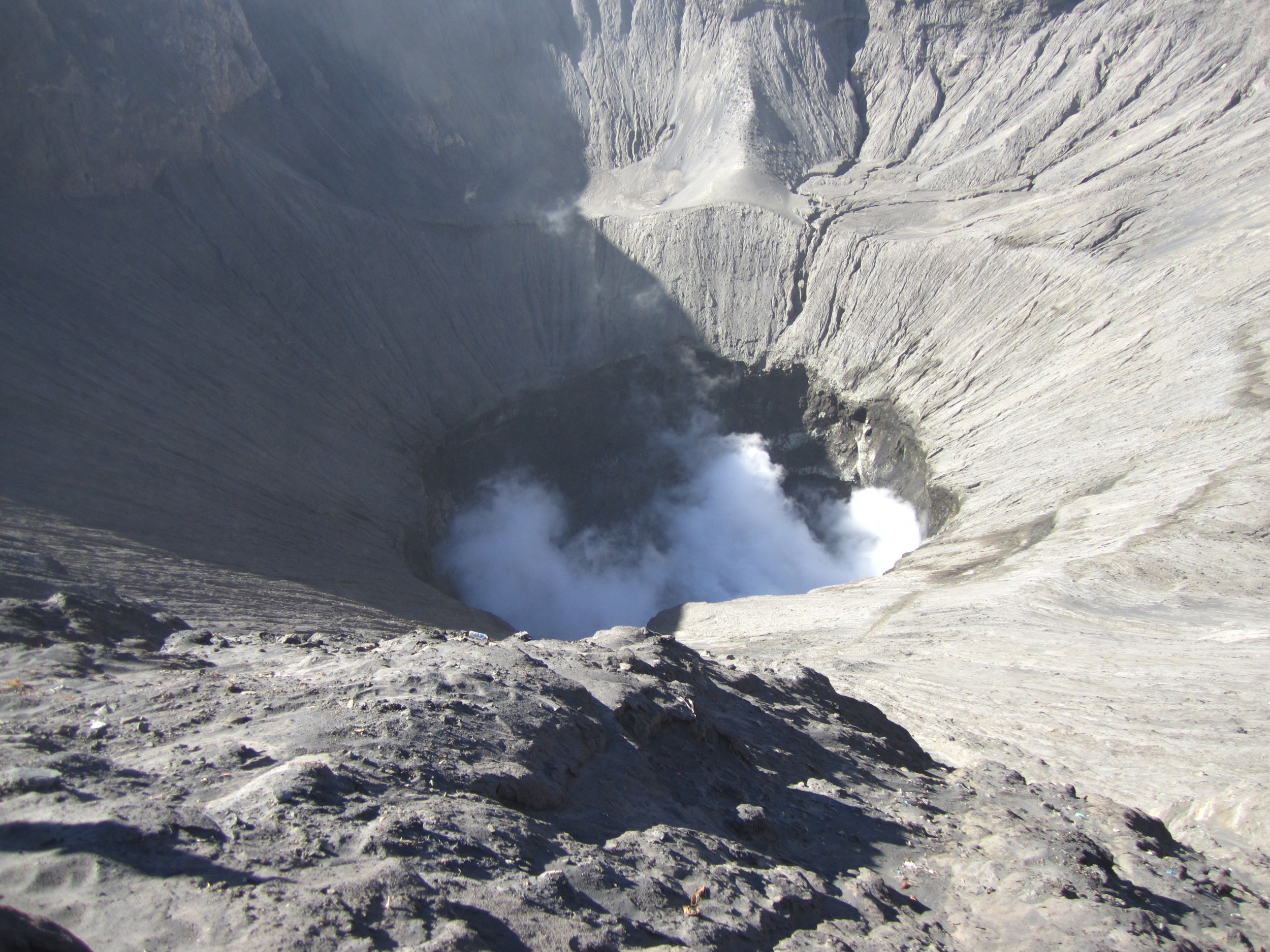 Bromo's massive crater spewing white sulphurous smoke