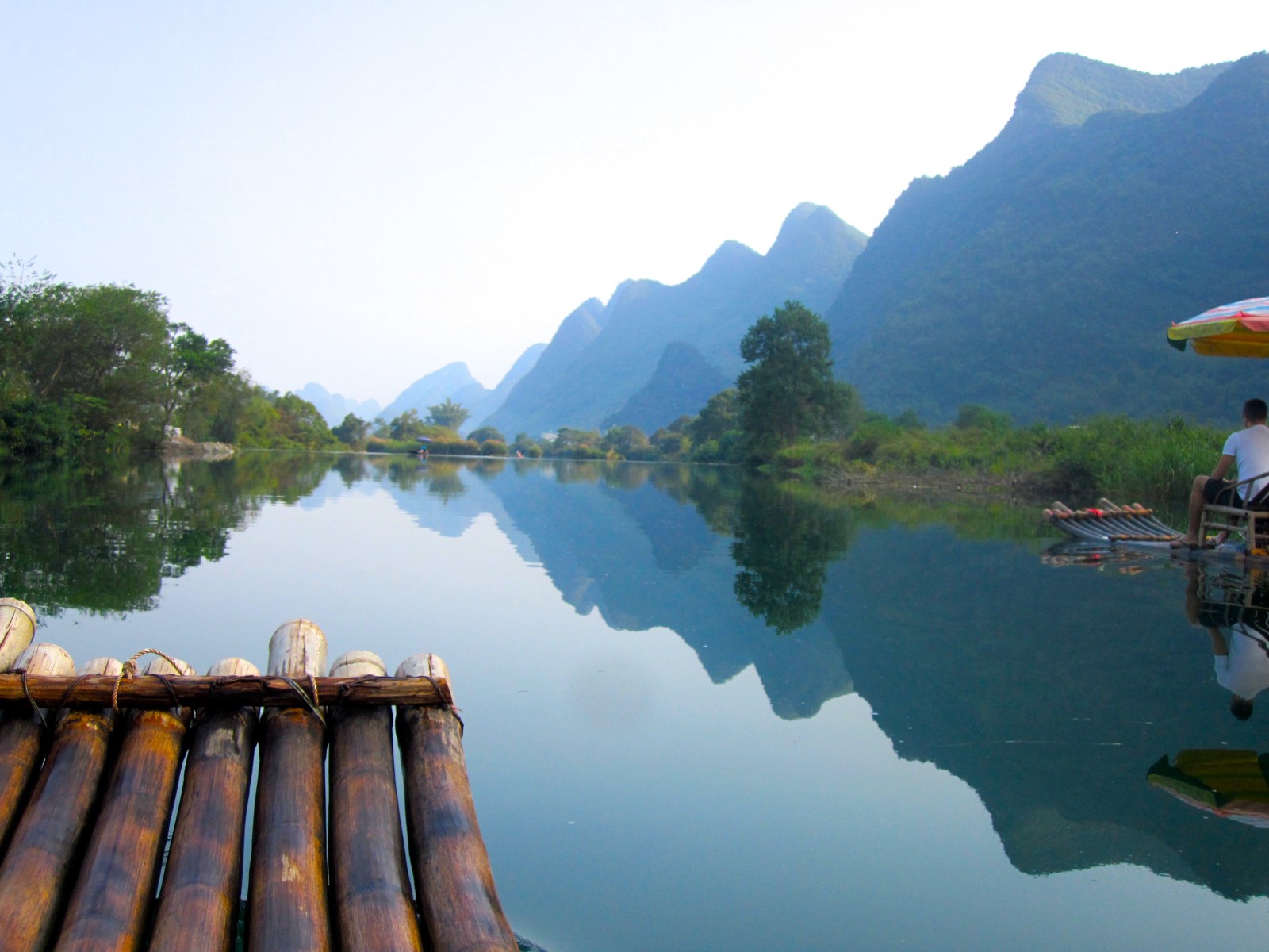 Rafting down the Yulong River among the limestone hills in Yangshuo, China 