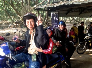 Local on motorbike waiting to get on the ferry near the Mekong Delta