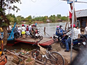 Groups of motorbikes in South Vietnam getting off the packed ferry