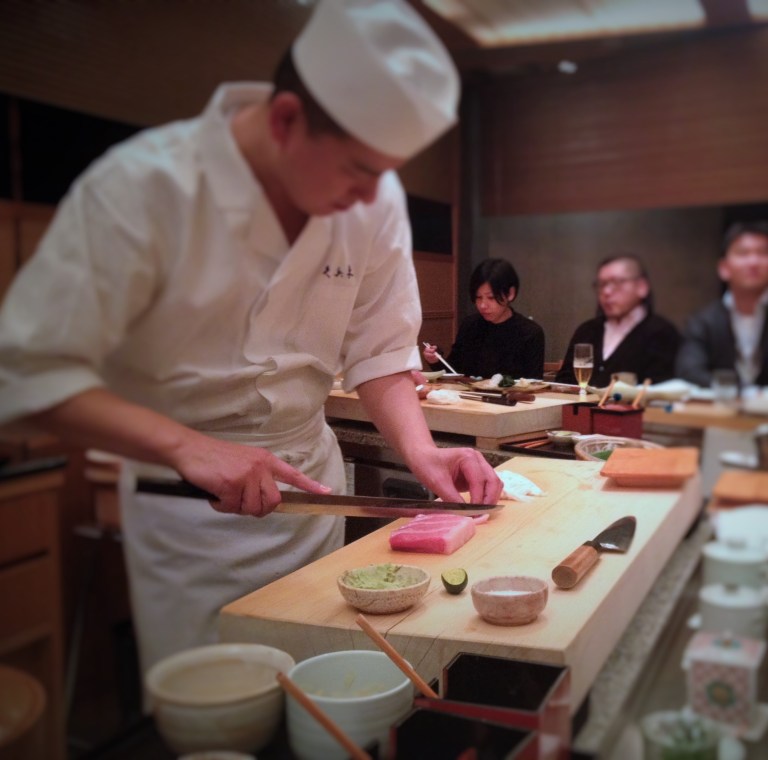 Our sushi chef at one of Tokyo's most prestigious sushi restaurants, Kyubei, slicing fresh tuna 