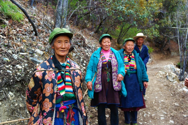Elder men and women making the pilgrimage to the Sacred Waterfall in Yubeng, China