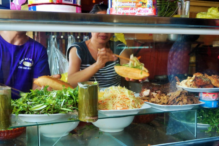 Woman making banh mi at Banh Mi Phuong in Hoi An's Old Town